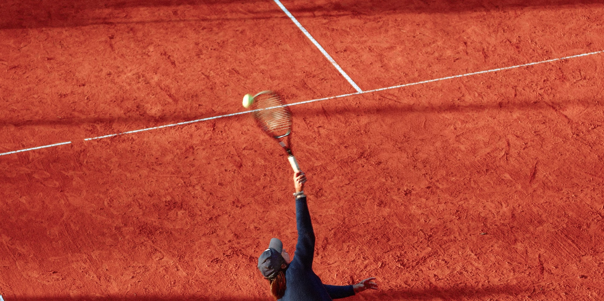 a man hitting a tennis ball with a racket