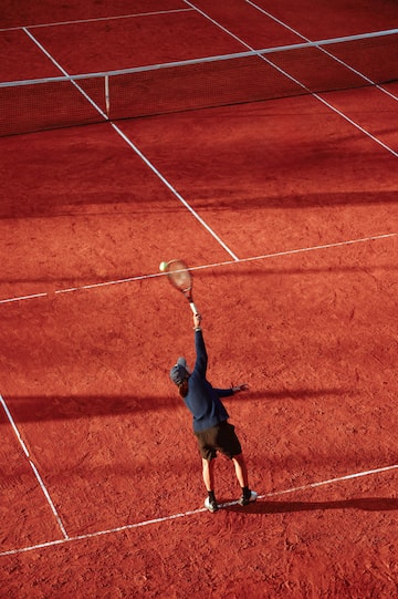 a man hitting a tennis ball with a racket