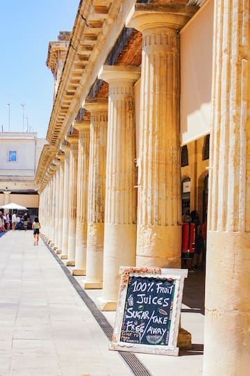 a building with columns and a sign