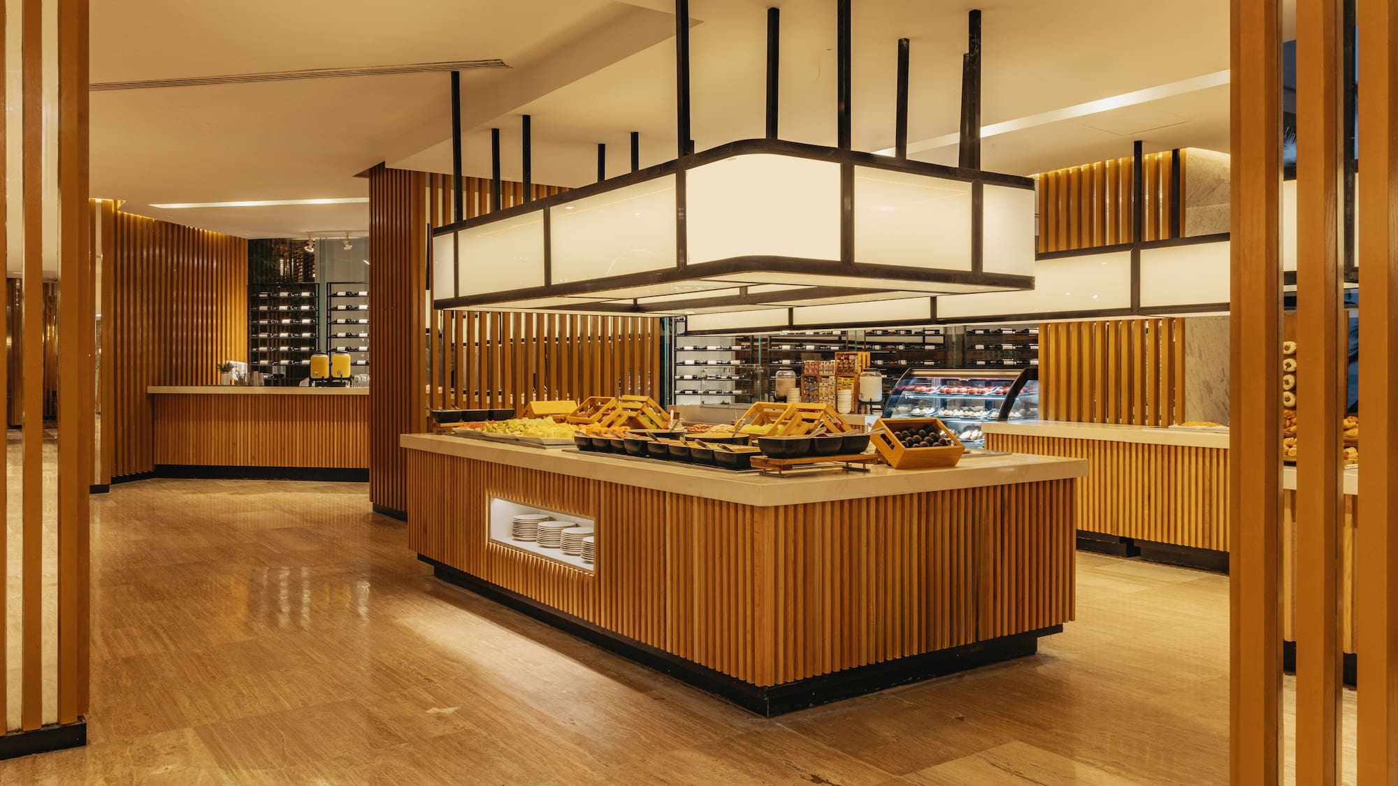 Hotel restaurant buffet with food, wood paneling, and contemporary design.