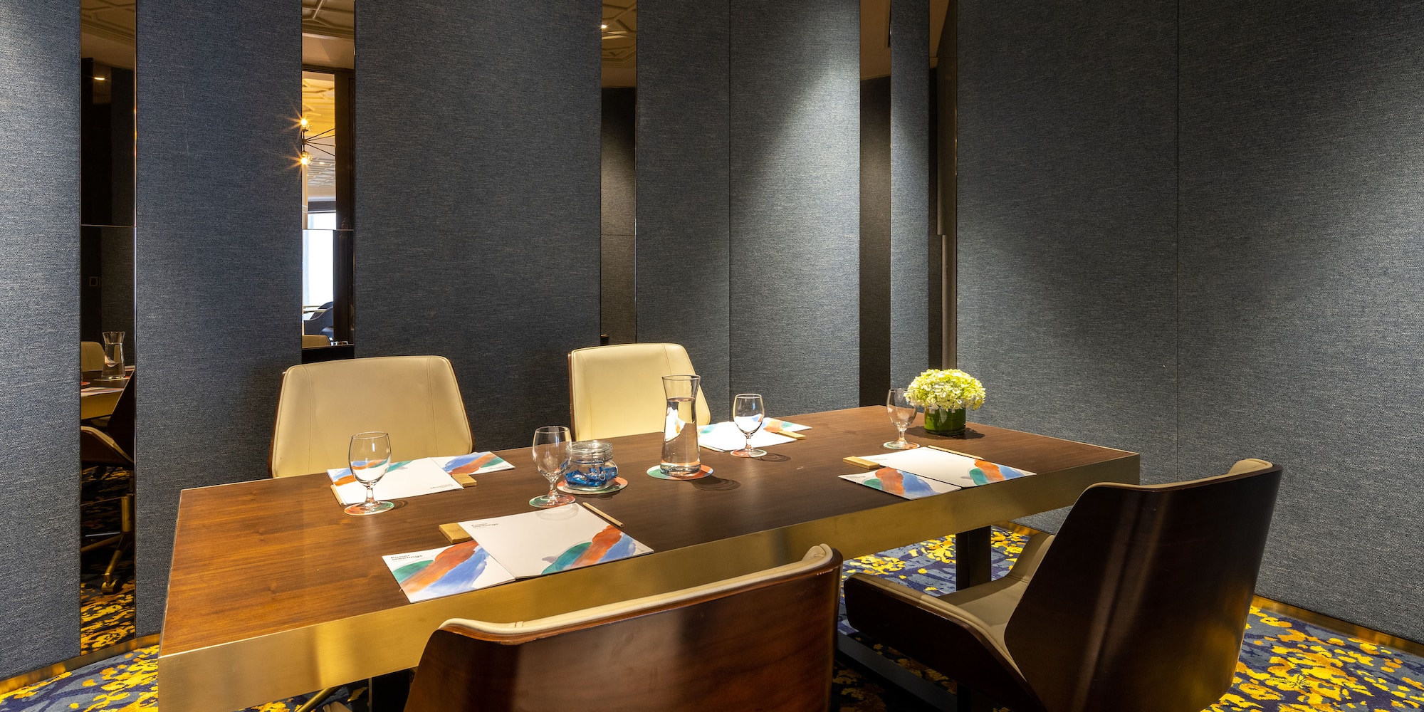 a table with chairs and glasses on it