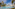 a pool with a white raft and palm trees
