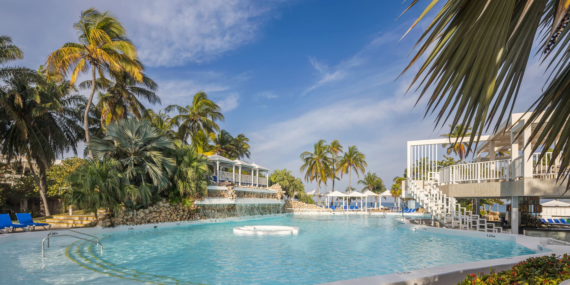 a pool with a white raft and palm trees