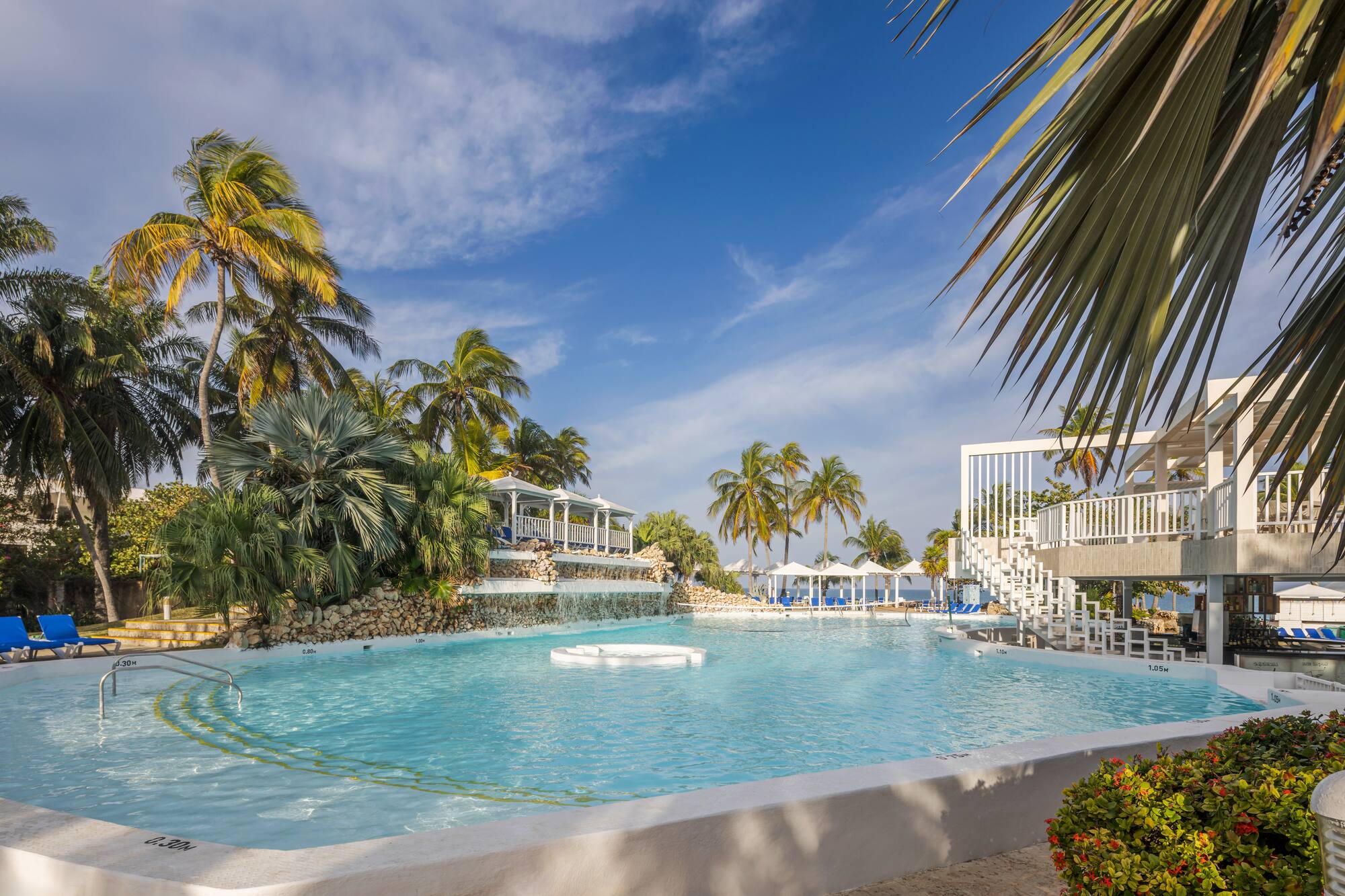 a pool with a white raft and palm trees