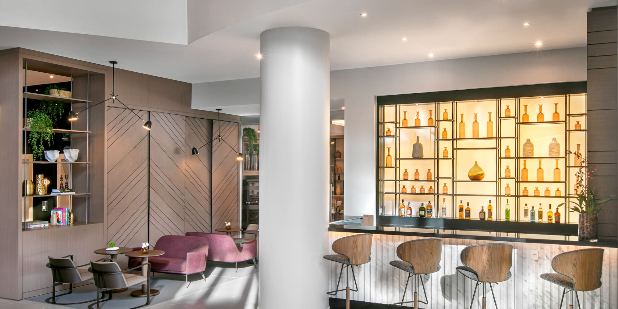 a room with a bar and stools