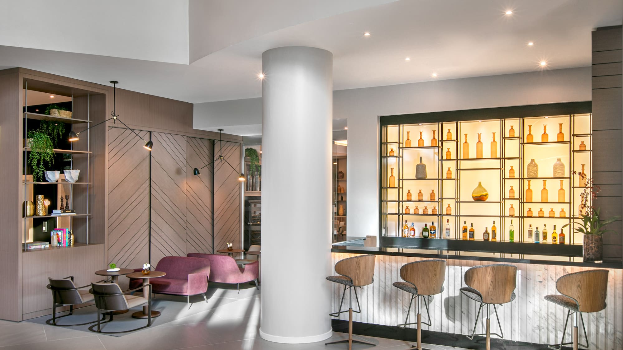 a room with a bar and stools