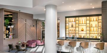 a room with a bar and stools