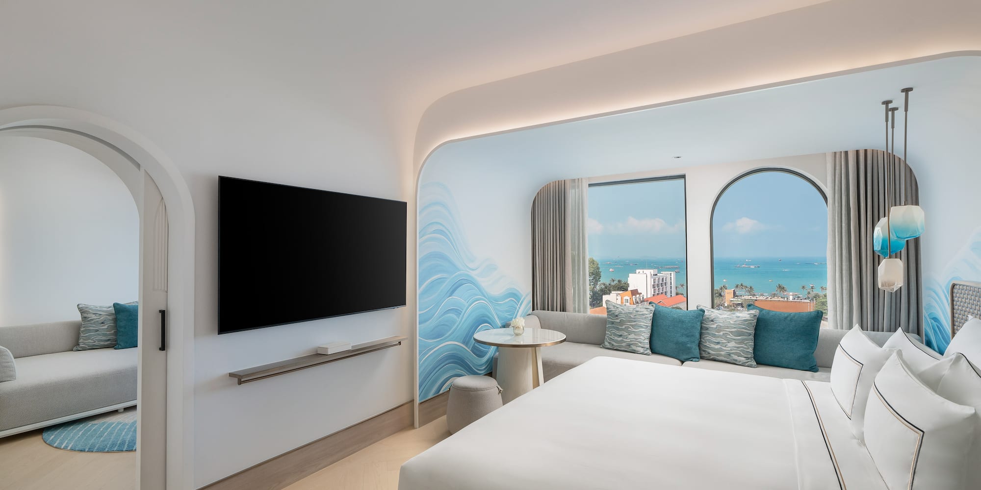 a room with a bed and a television