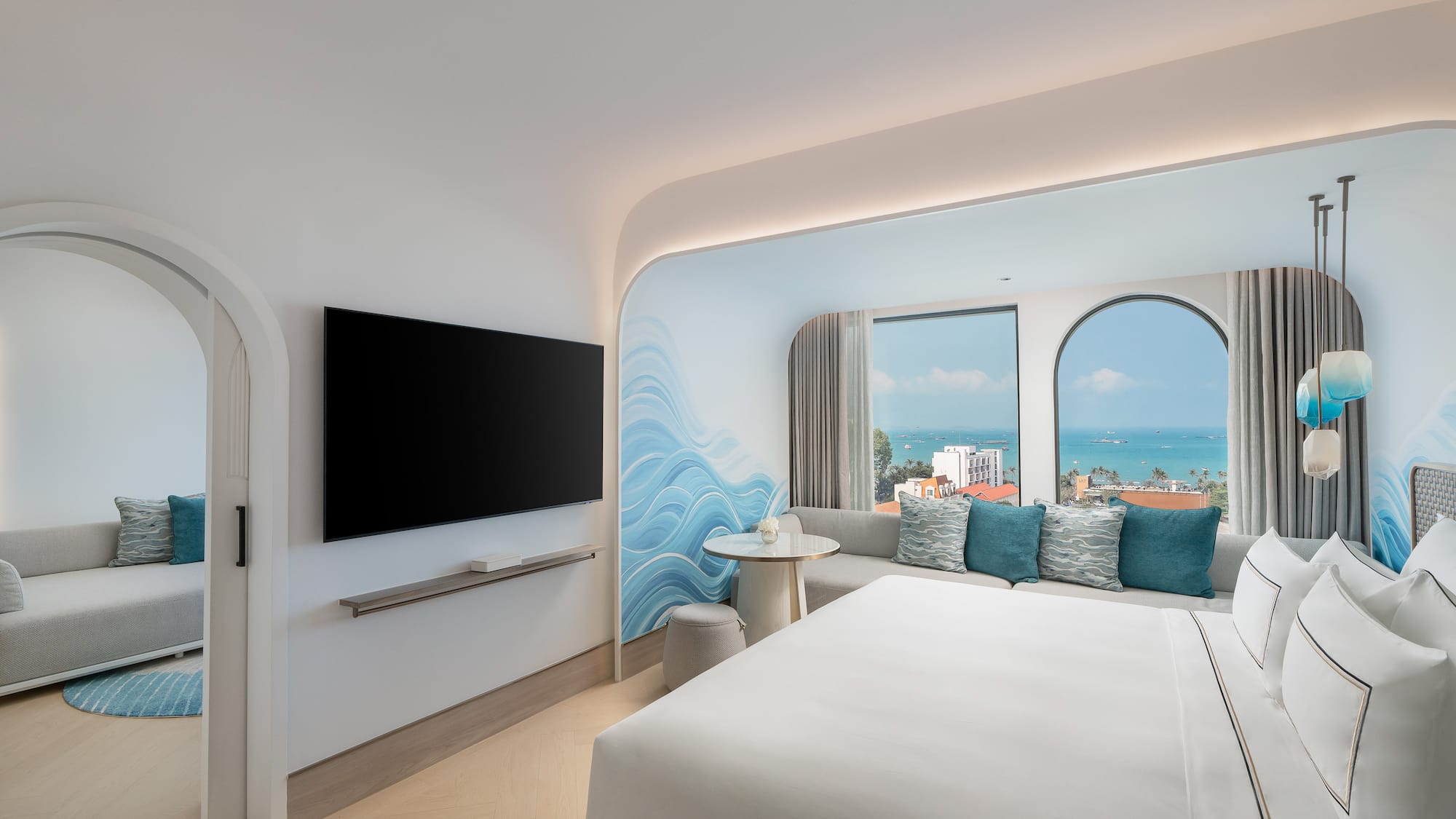 a room with a bed and a television