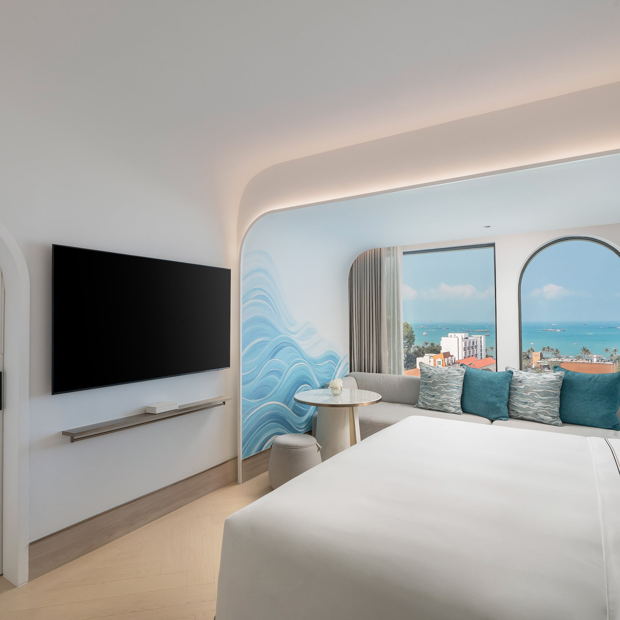 a room with a bed and a television