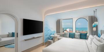 a room with a bed and a television