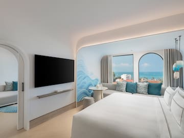 a room with a bed and a television