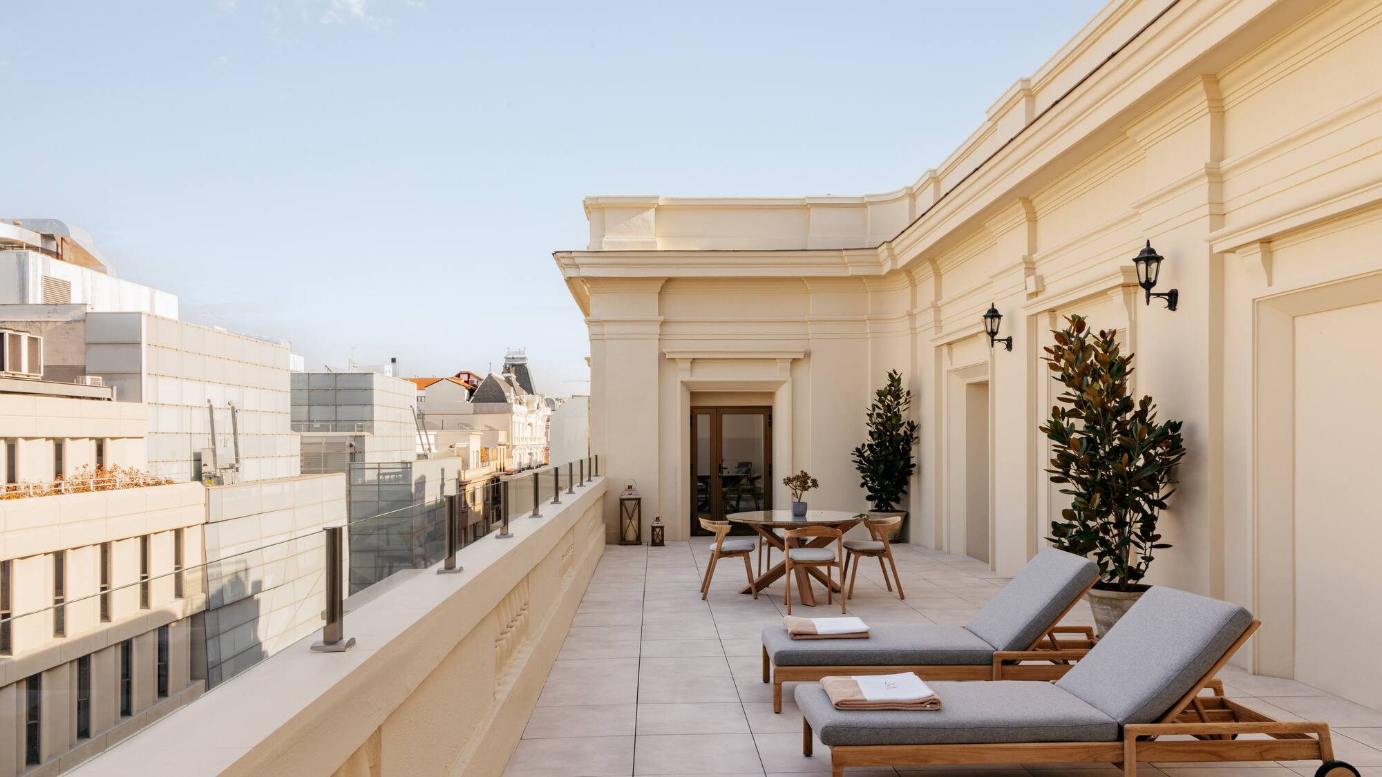 a patio with chairs and tables on a rooftop