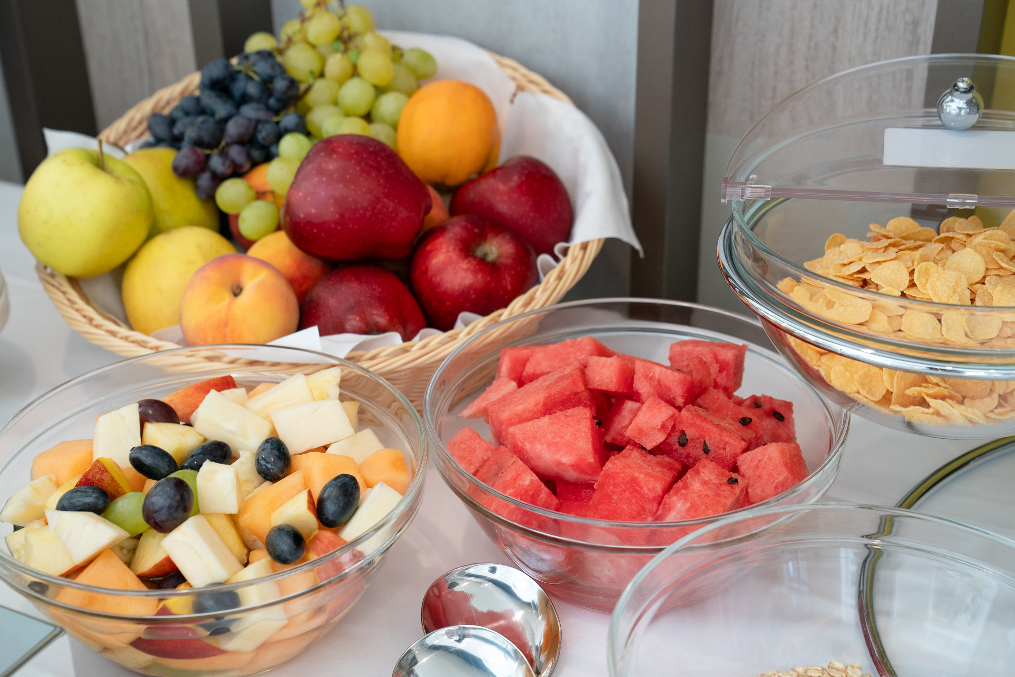 Colorful fresh fruit, fruit salad, watermelon, cornflakes on breakfast buffet.