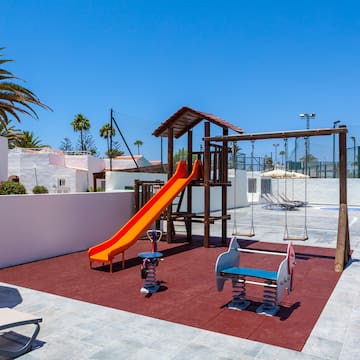 a playground with swings and a slide