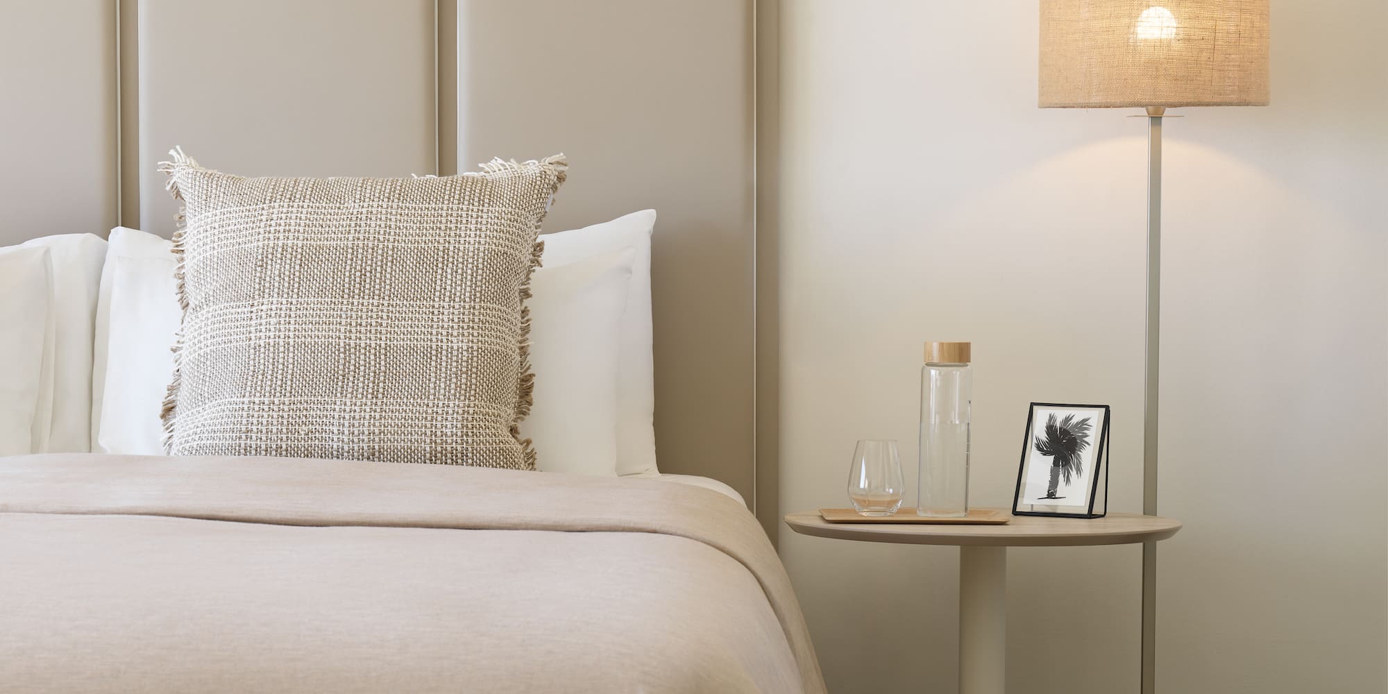 a bed with a lamp next to it