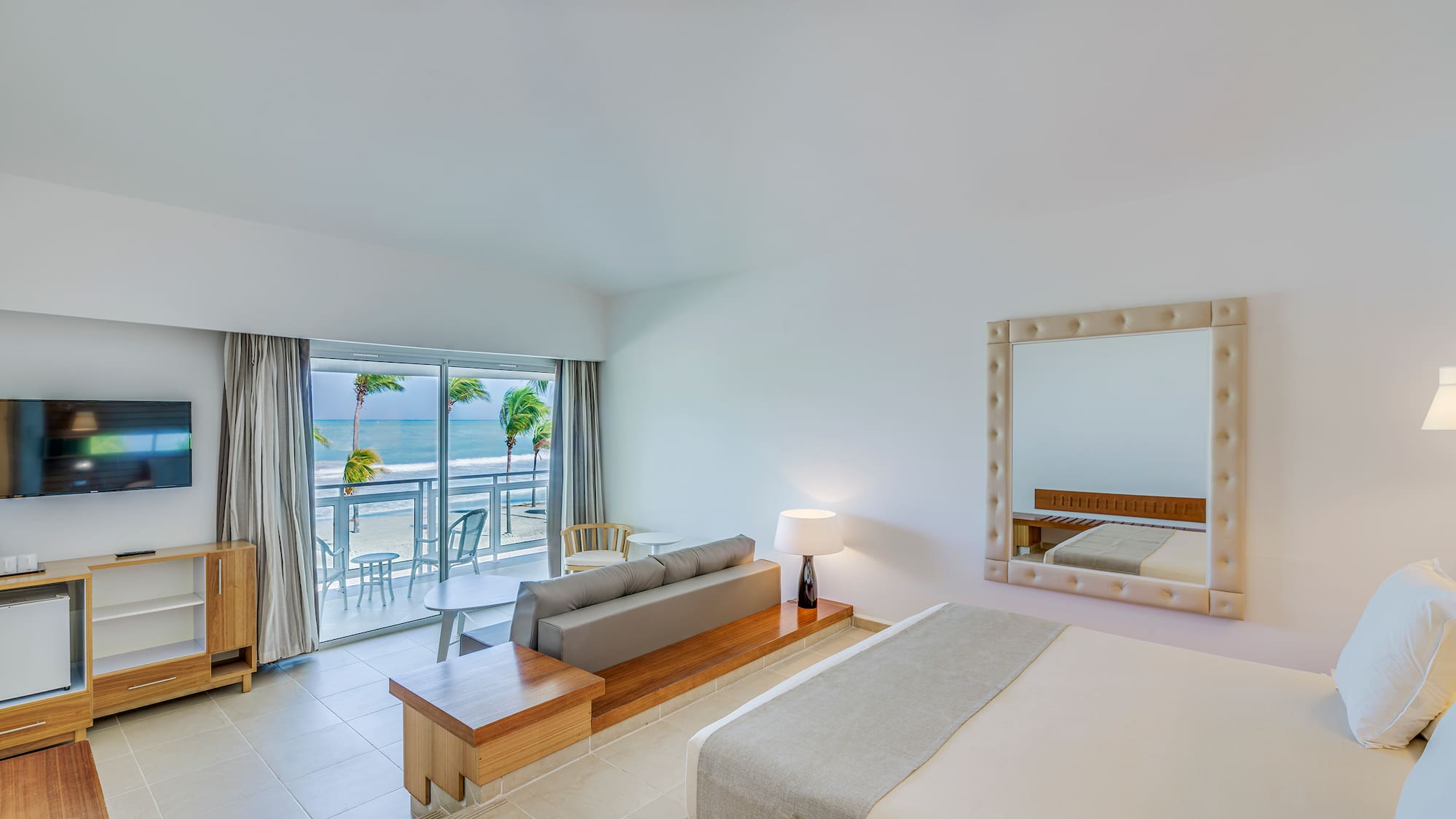 a room with a bed and a mirror and a table