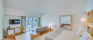 a room with a bed and a mirror and a table