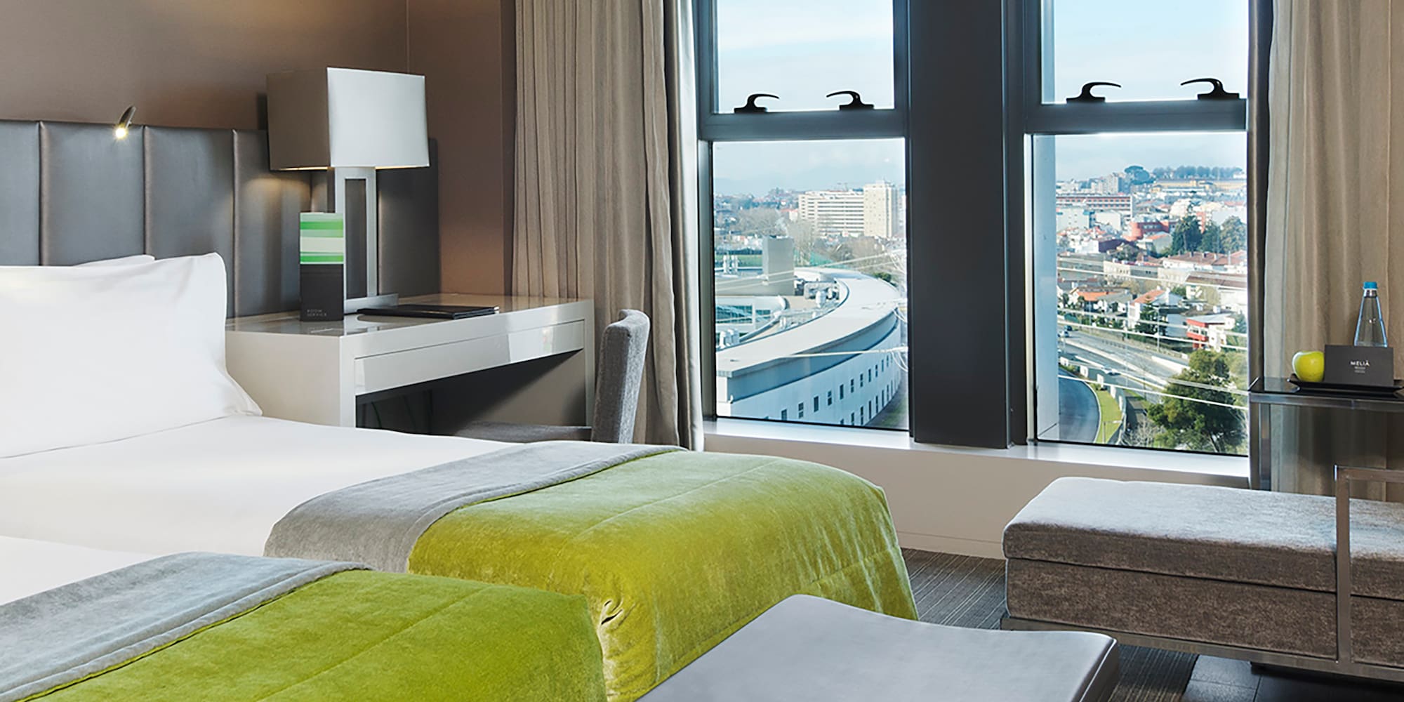 a room with two beds and a bench