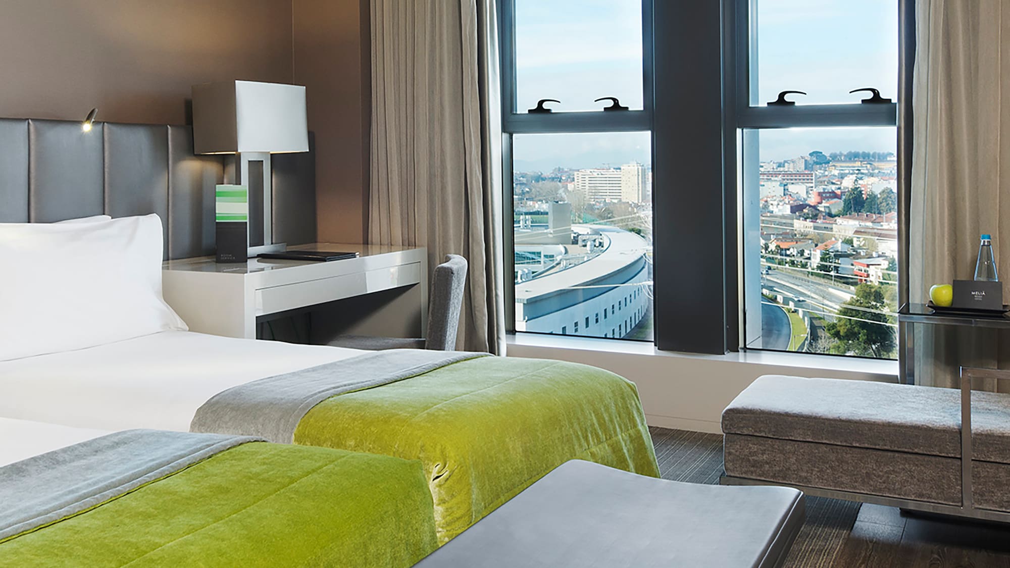 a room with two beds and a bench