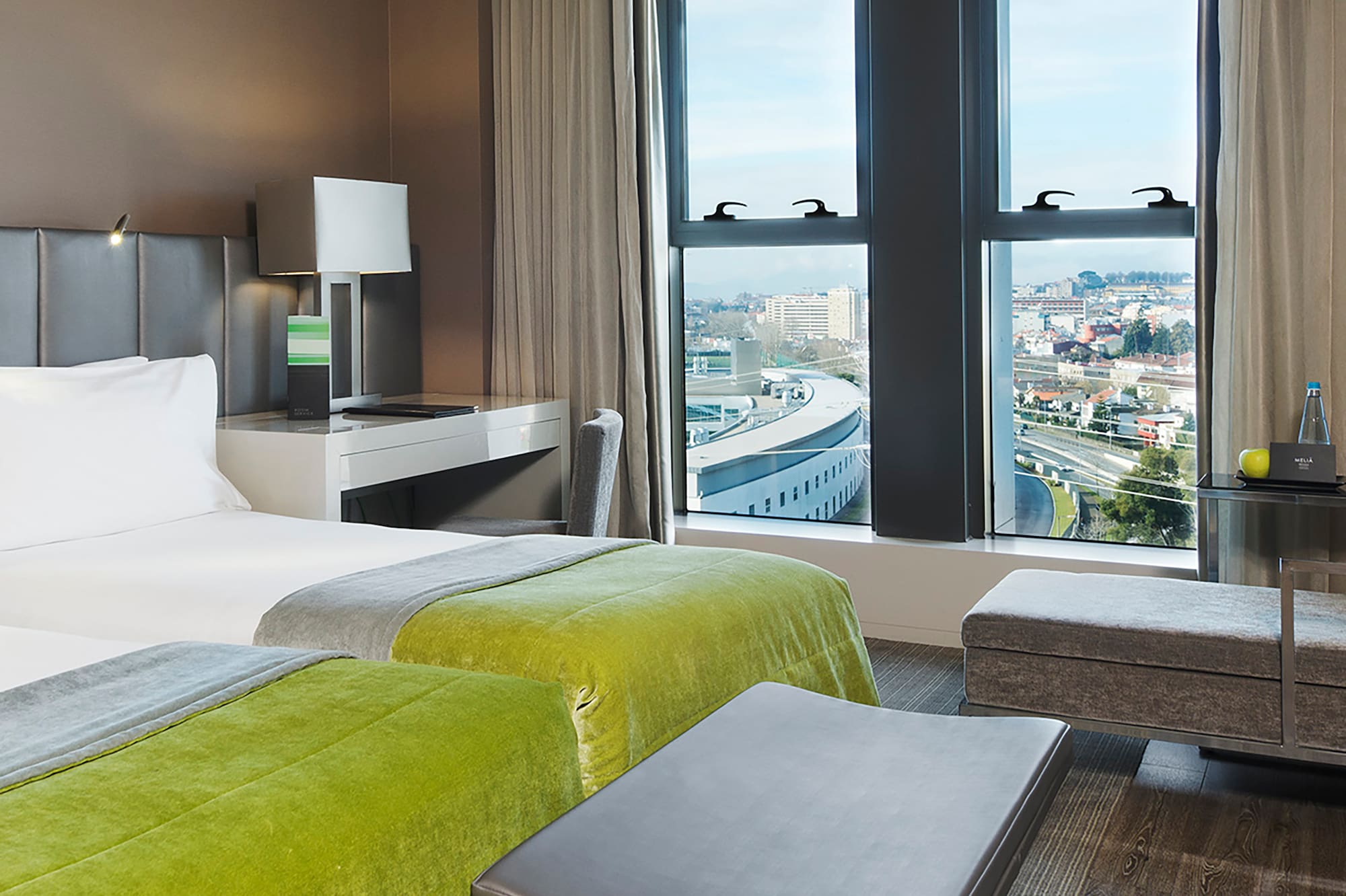 a room with two beds and a bench