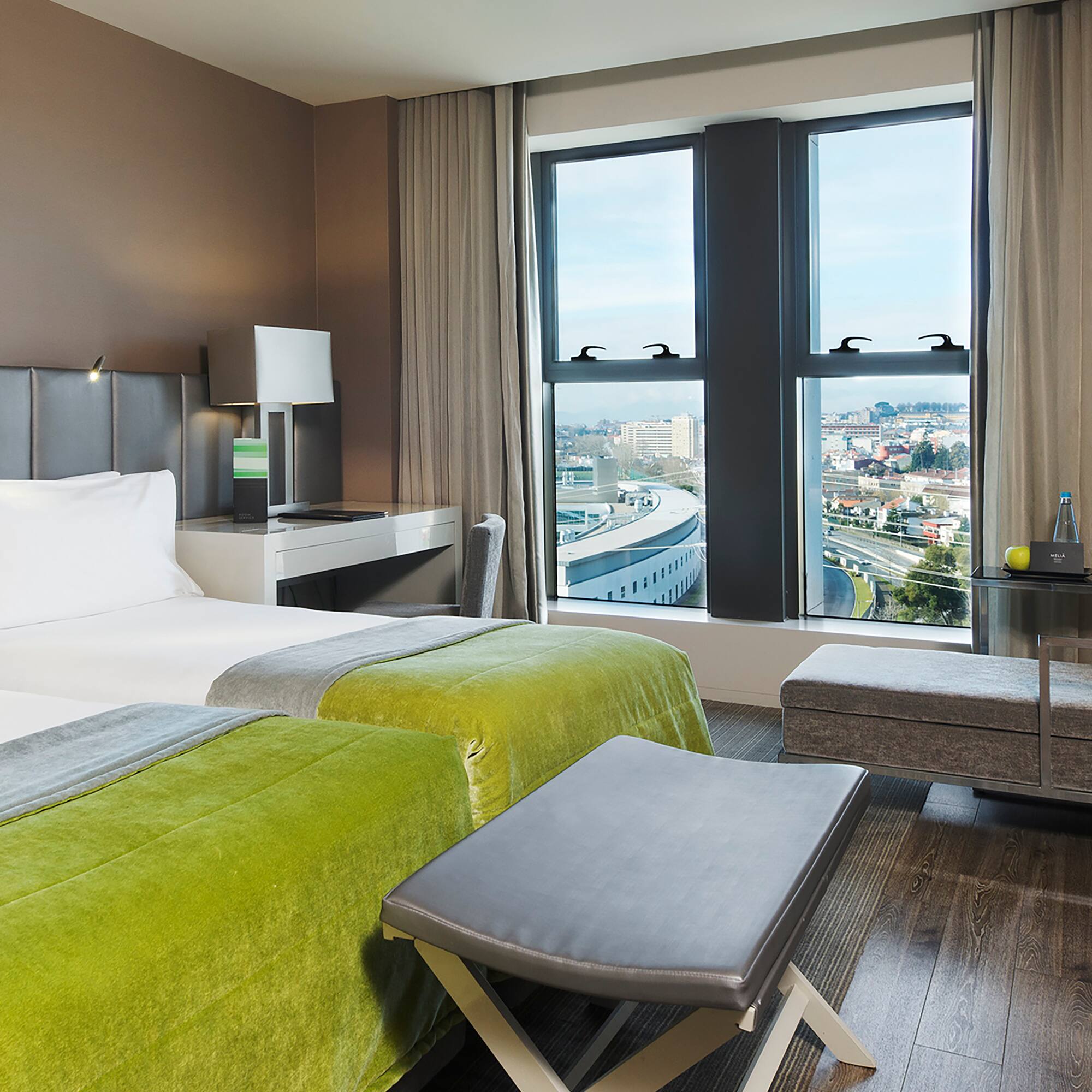 a room with two beds and a bench