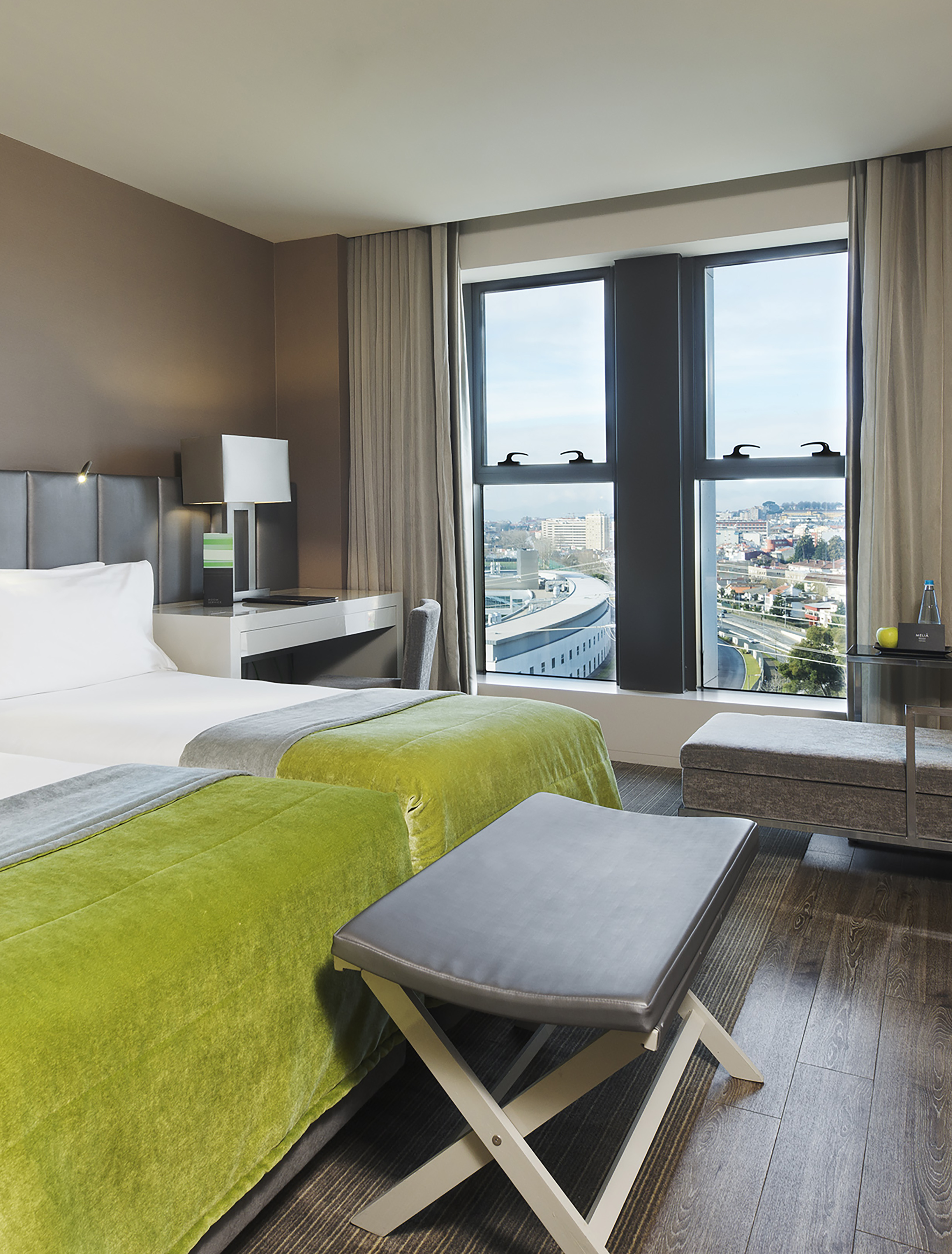 a room with two beds and a bench