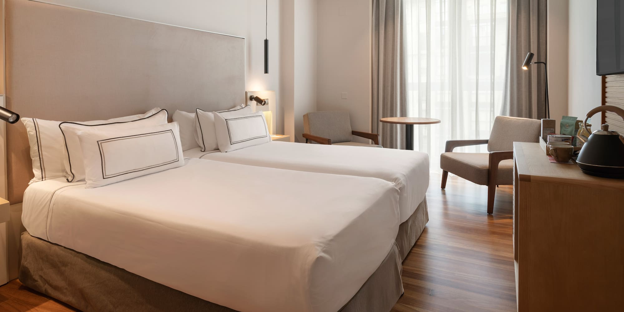 a room with two beds and a table