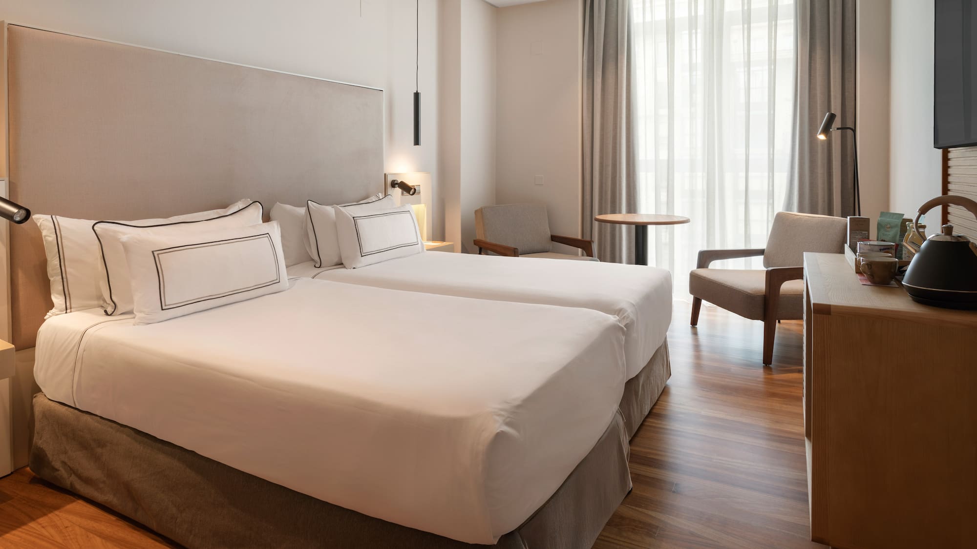 a room with two beds and a table