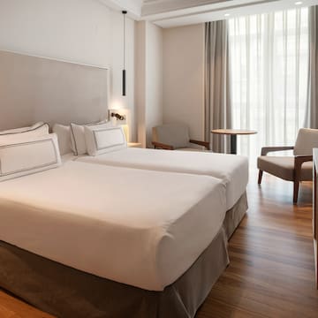 a room with two beds and a table