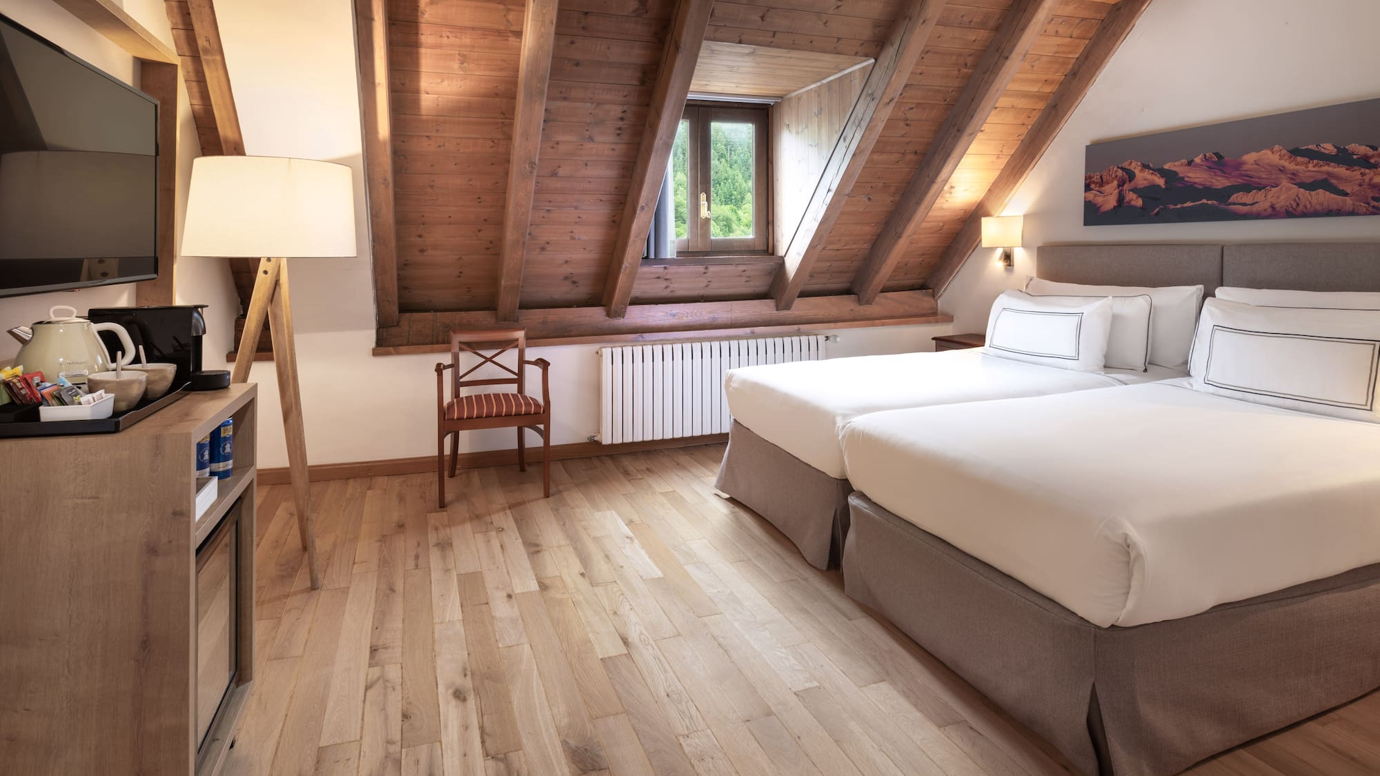 a room with two beds and a wood floor