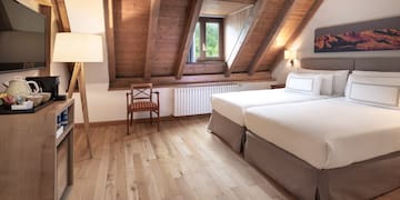 a room with two beds and a wood floor