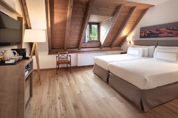 a room with two beds and a wood floor