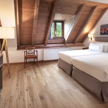 a room with two beds and a wood floor