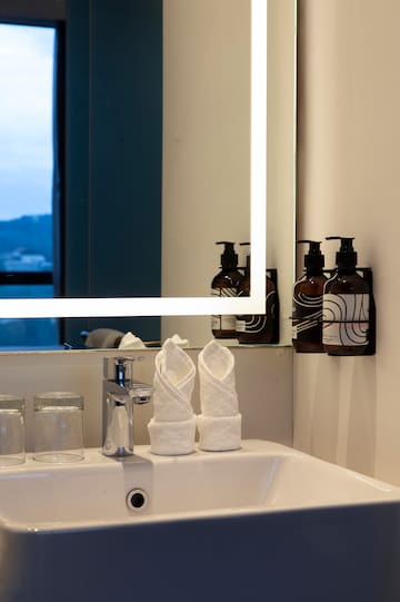 a bathroom sink with a mirror and towels