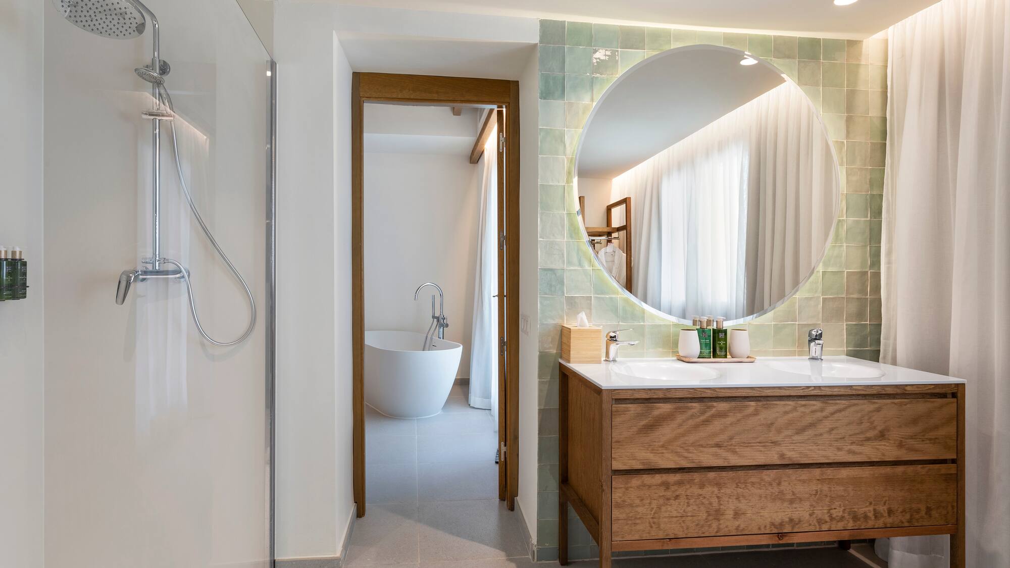 a bathroom with a large round mirror