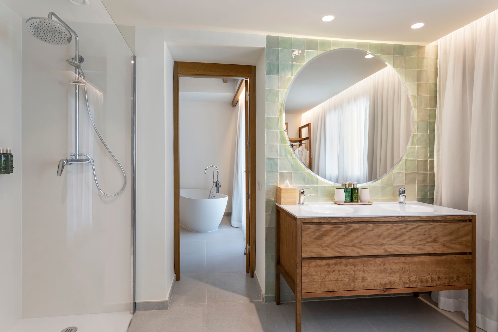 a bathroom with a large round mirror