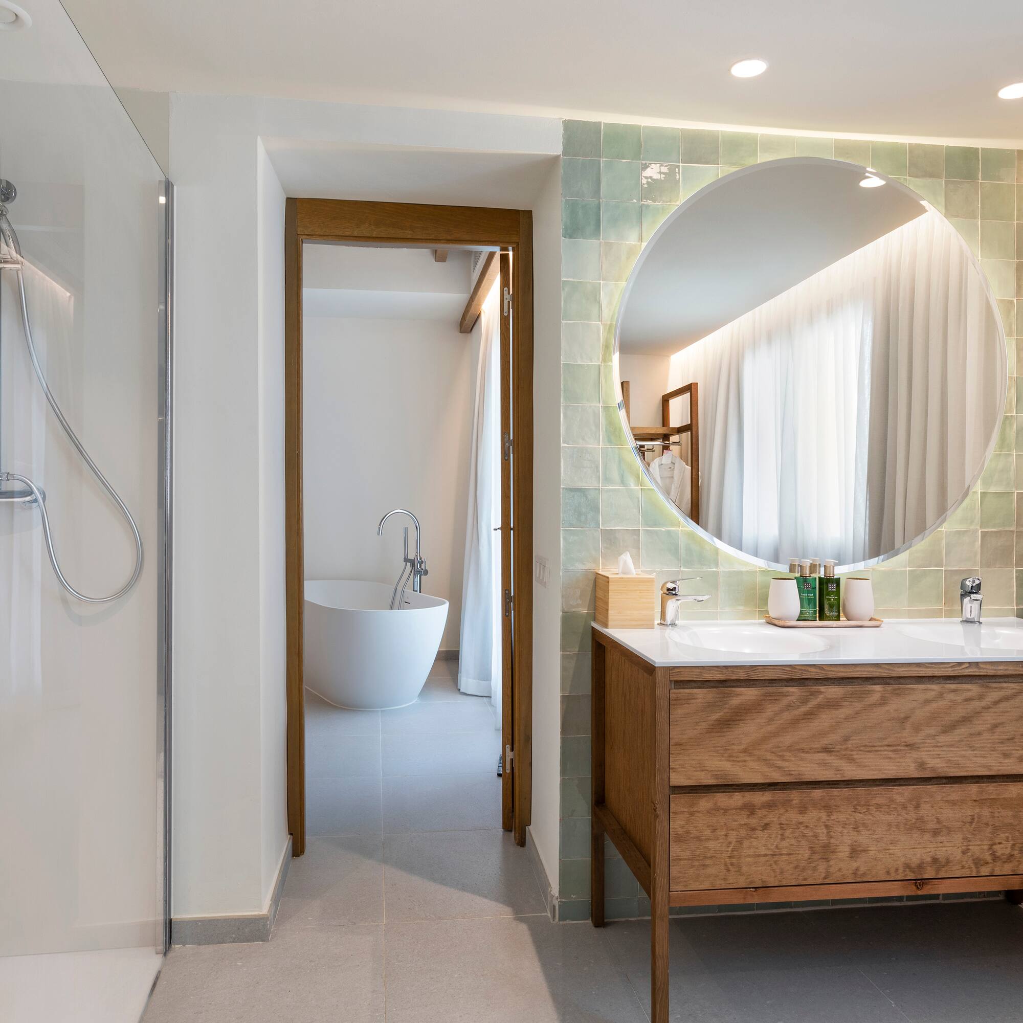a bathroom with a large round mirror
