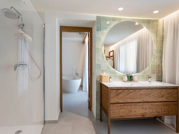 a bathroom with a large round mirror