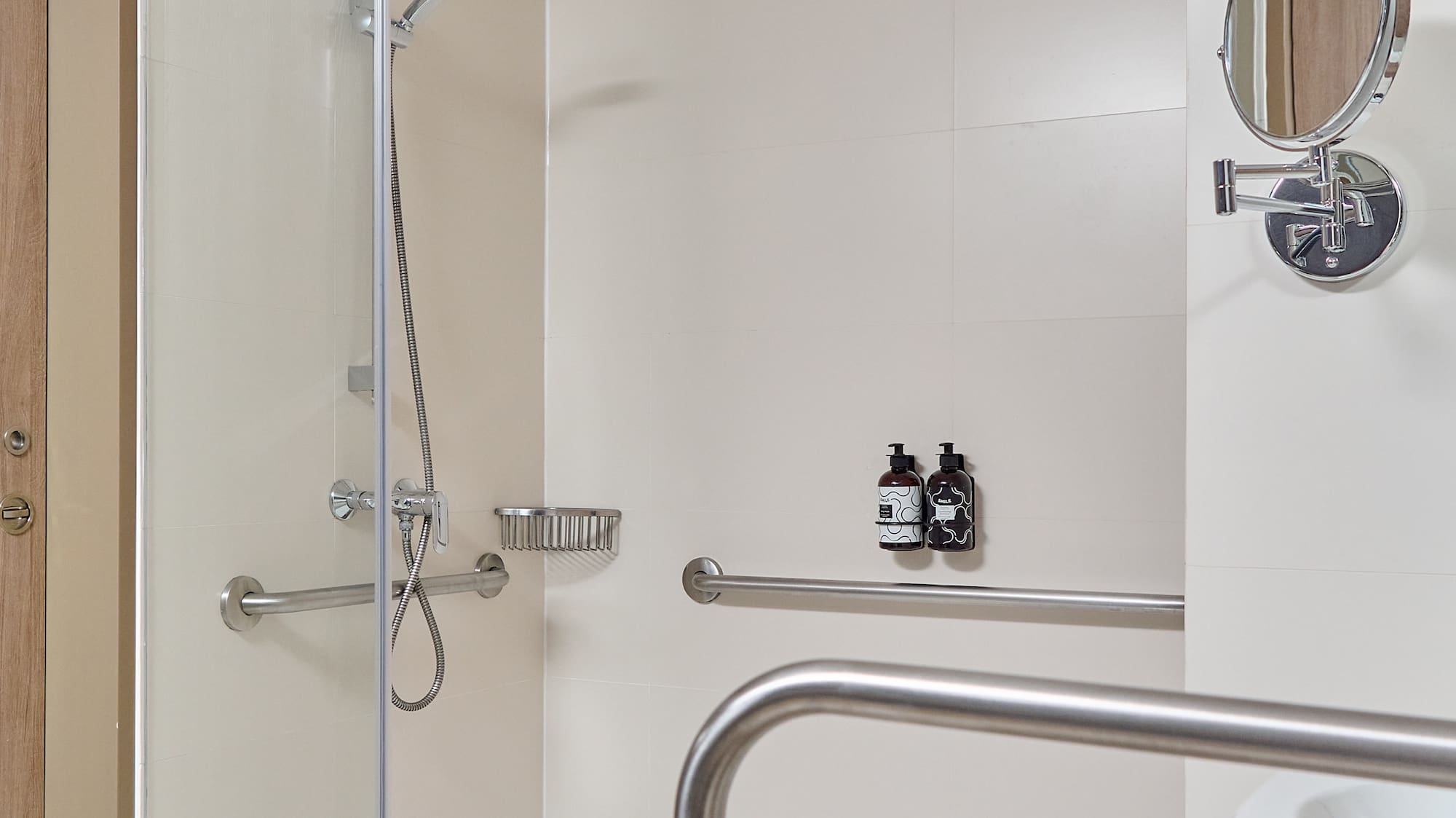 a shower with a mirror and a round mirror