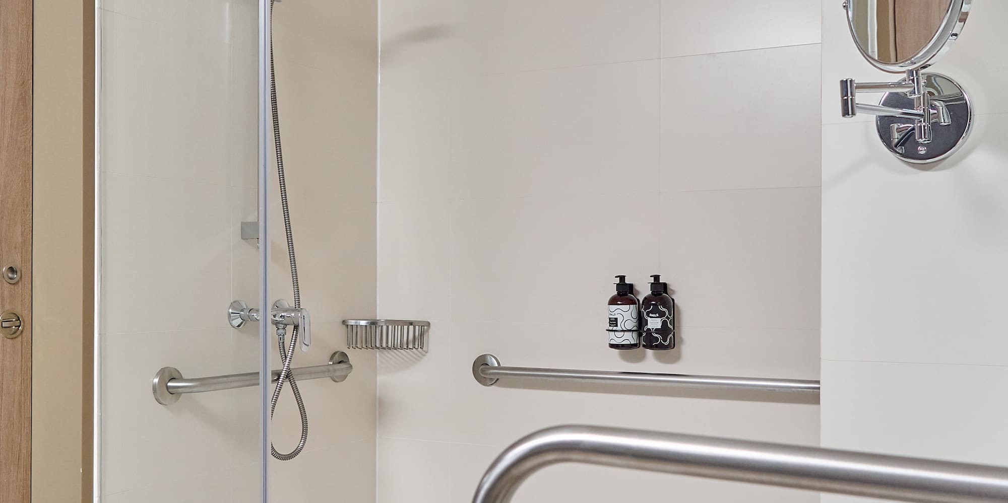 a shower with a mirror and a round mirror