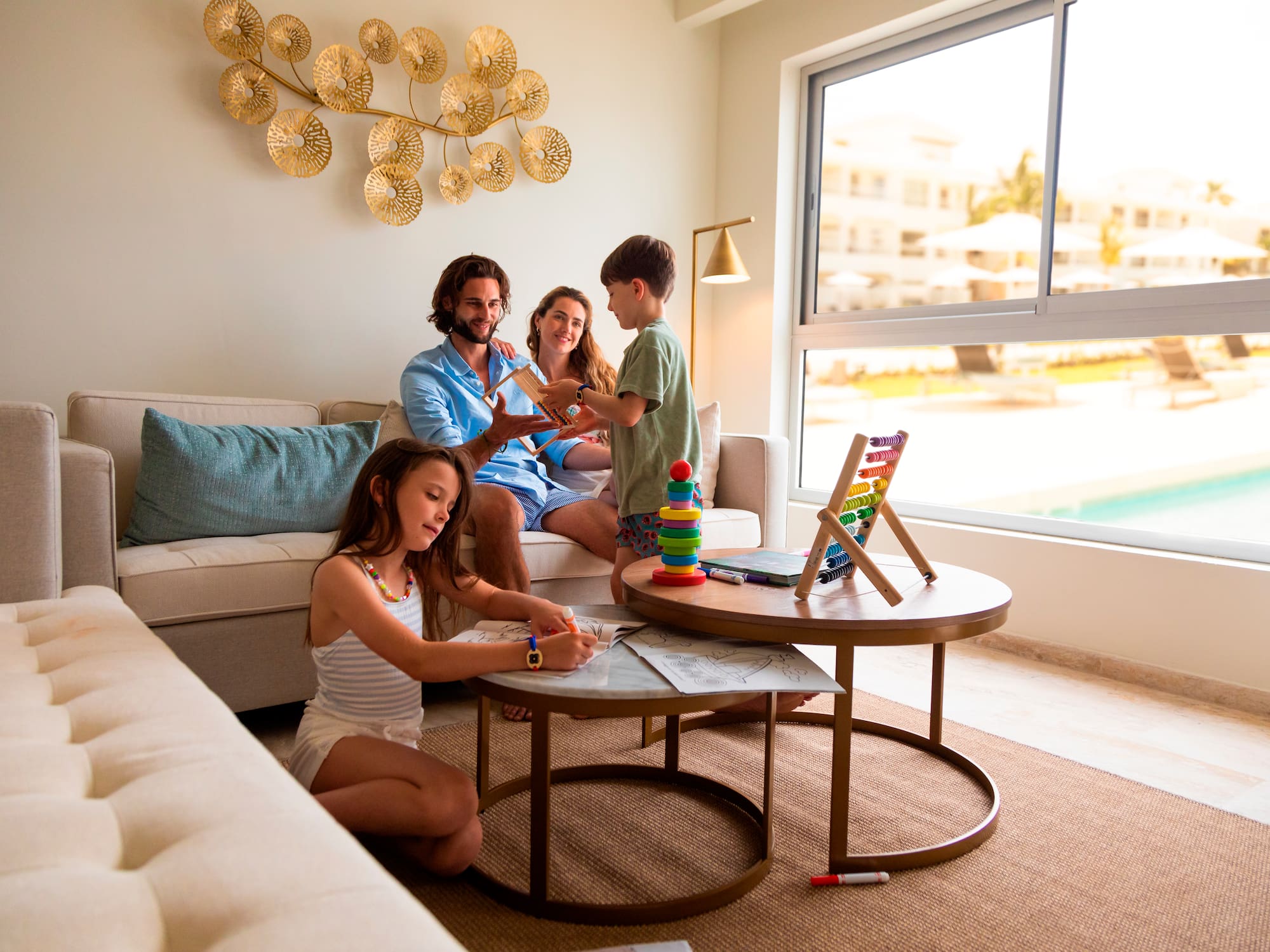 a family sitting on a couch playing with toys