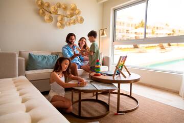 a family sitting on a couch playing with toys