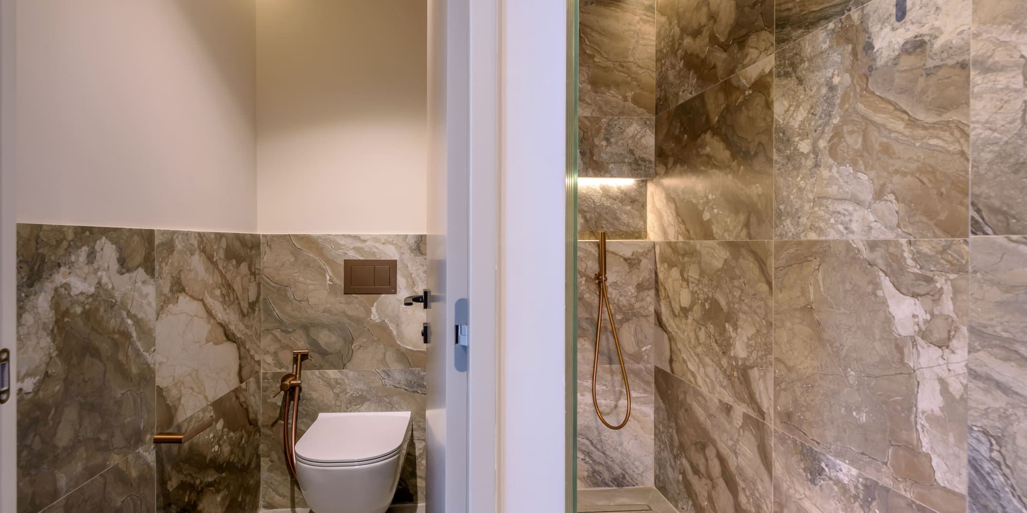 a bathroom with a toilet and shower.