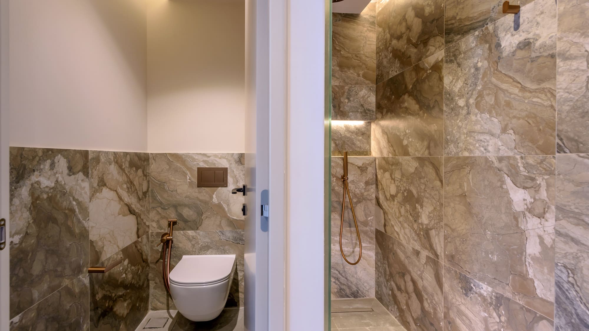 a bathroom with a toilet and shower.