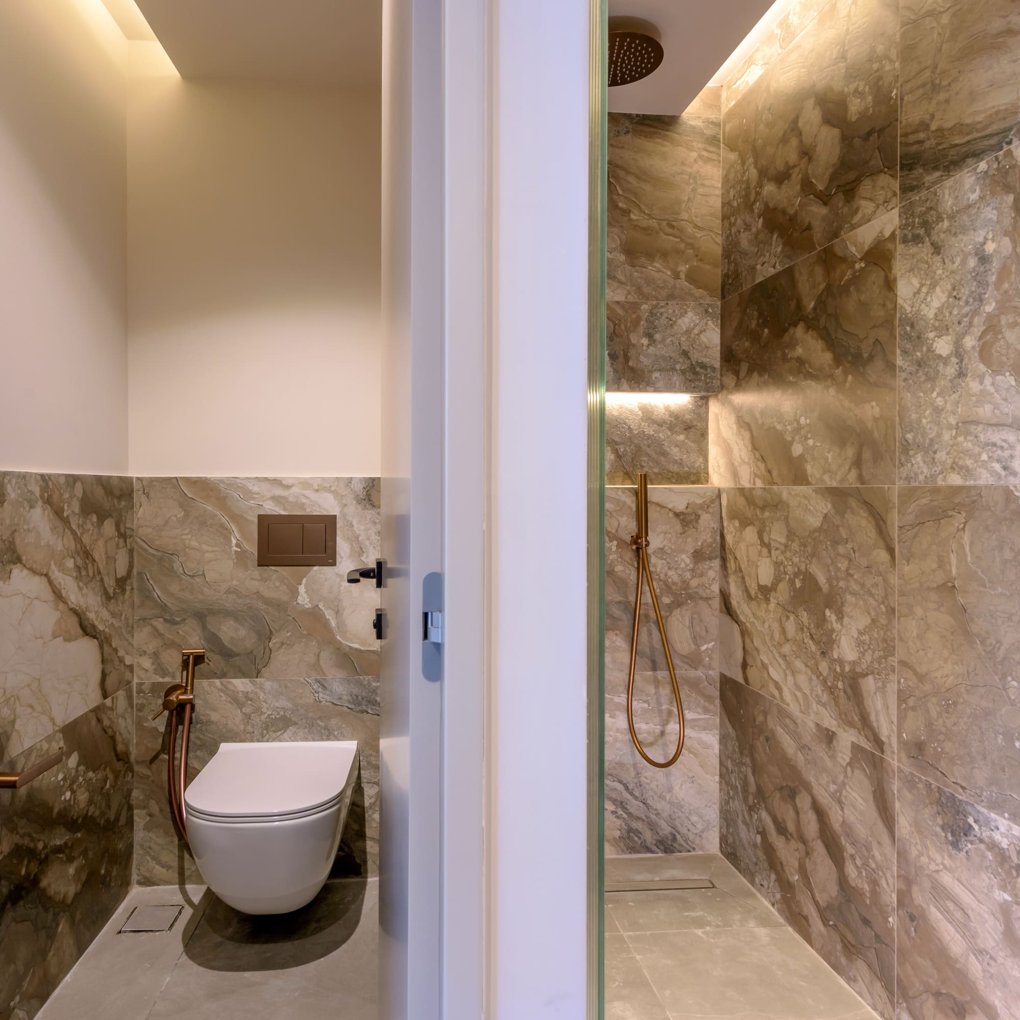 a bathroom with a toilet and shower.