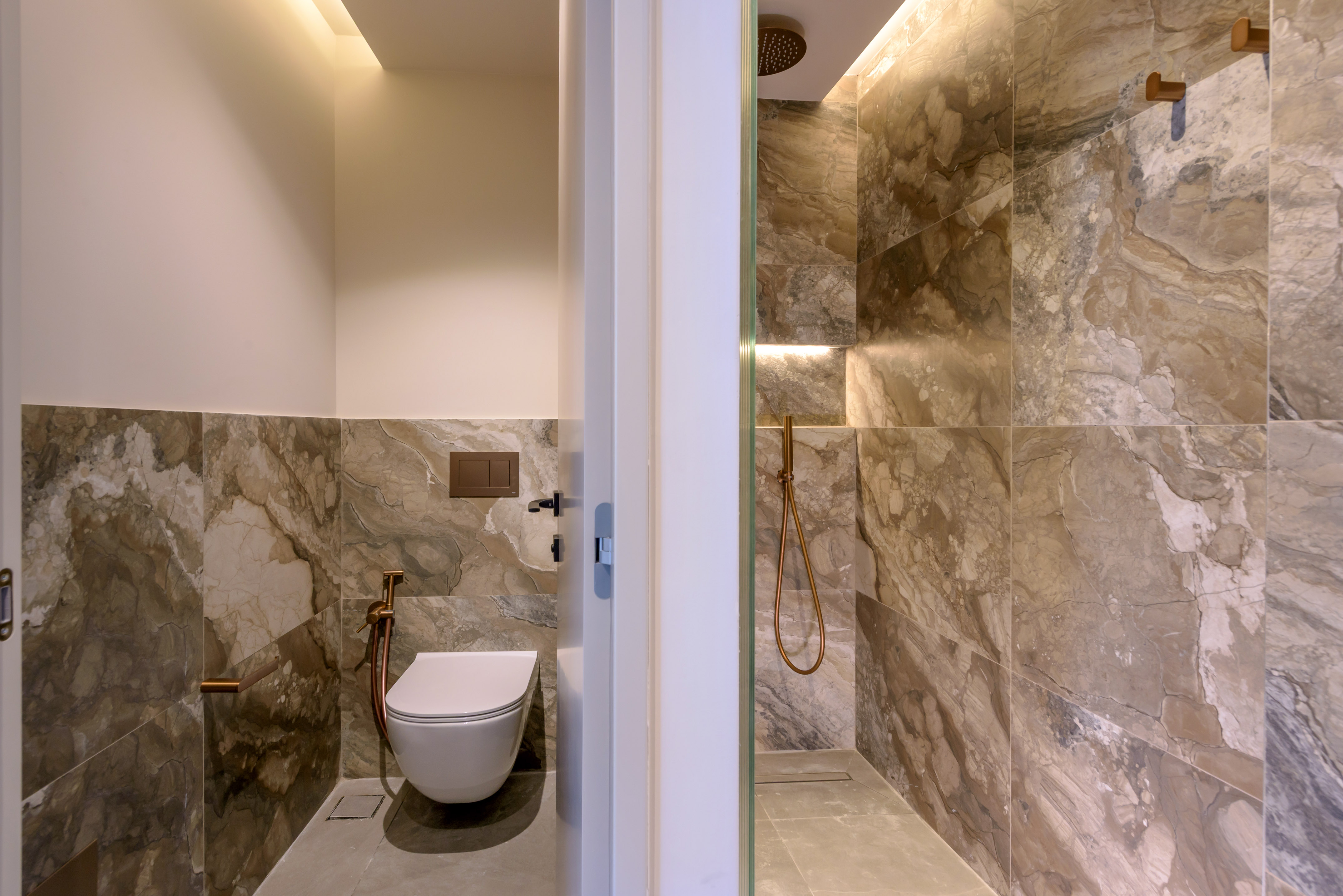 a bathroom with a toilet and shower.