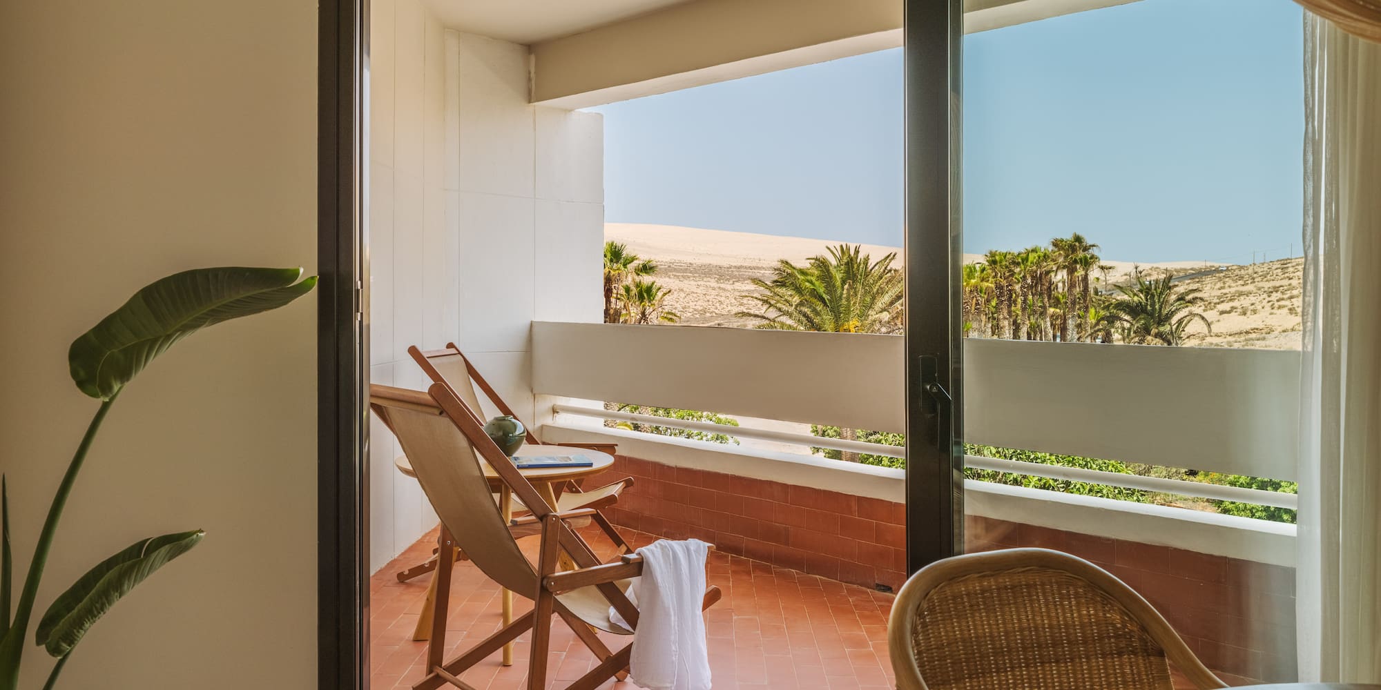 a chair and table on a balcony