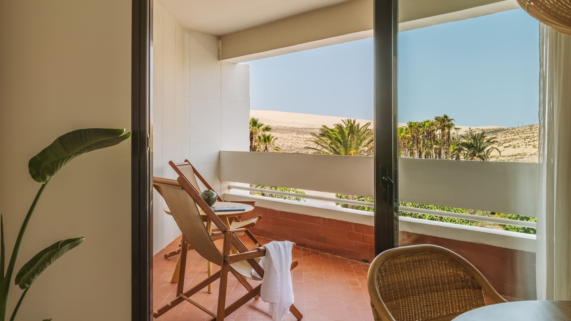 a chair and table on a balcony
