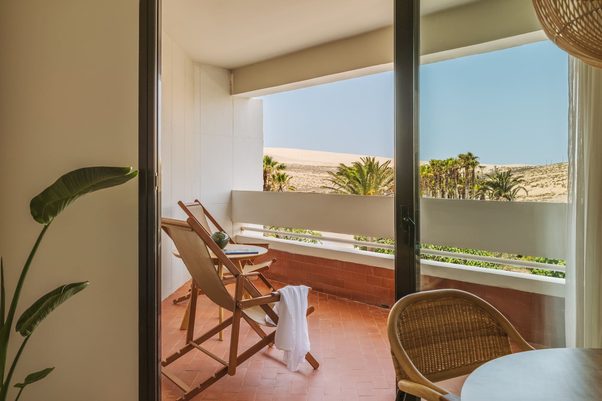 a chair and table on a balcony